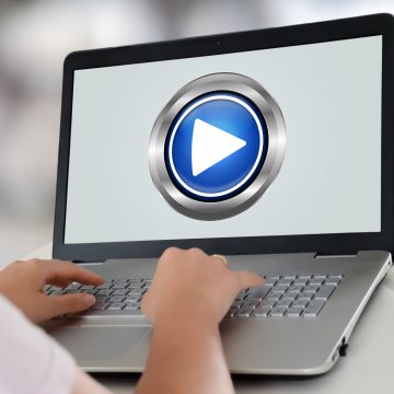 typing on laptop vpn services play button on screen streaming 